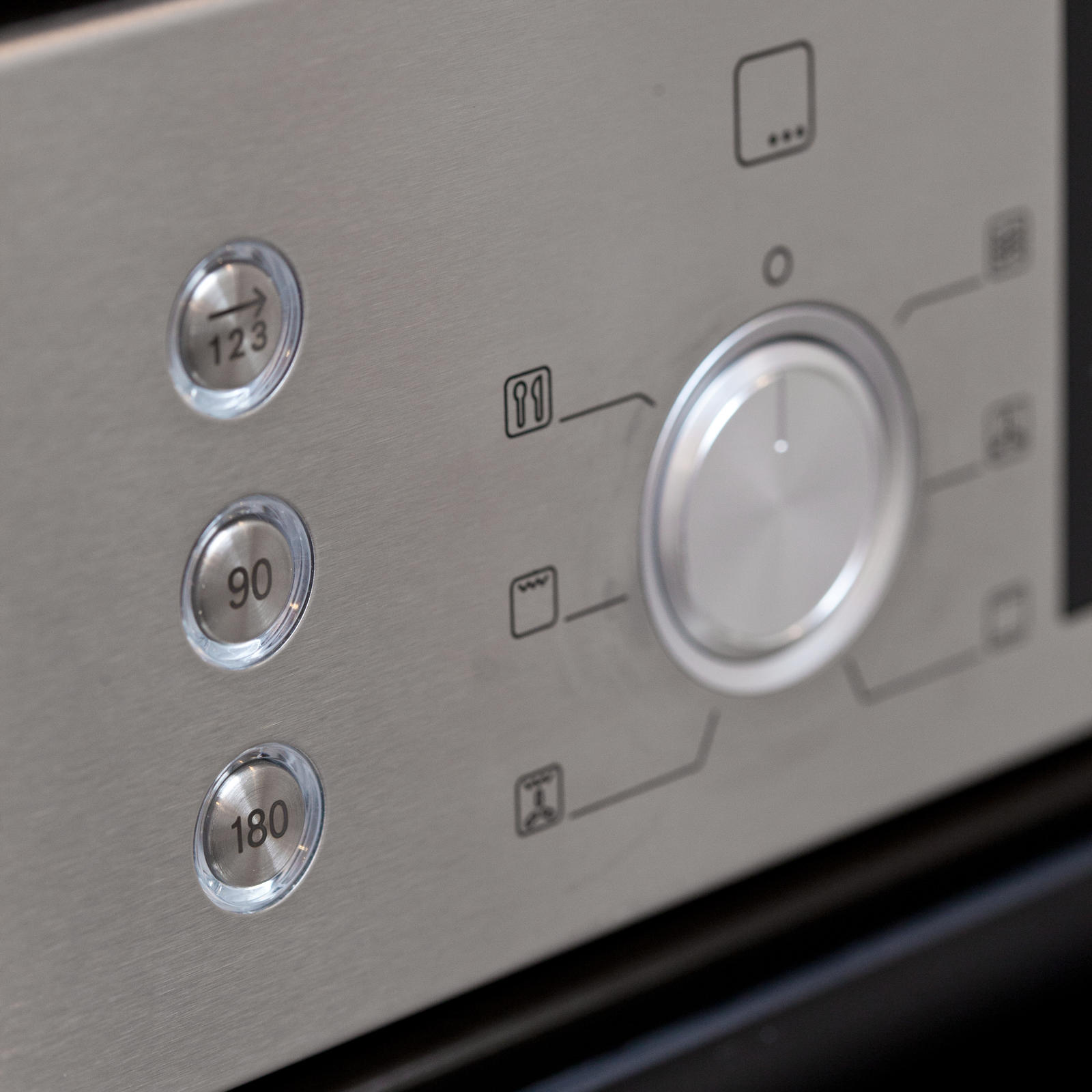 Bedieningspaneel van een RVS oven met draaiknop en snelkeuzetoetsen