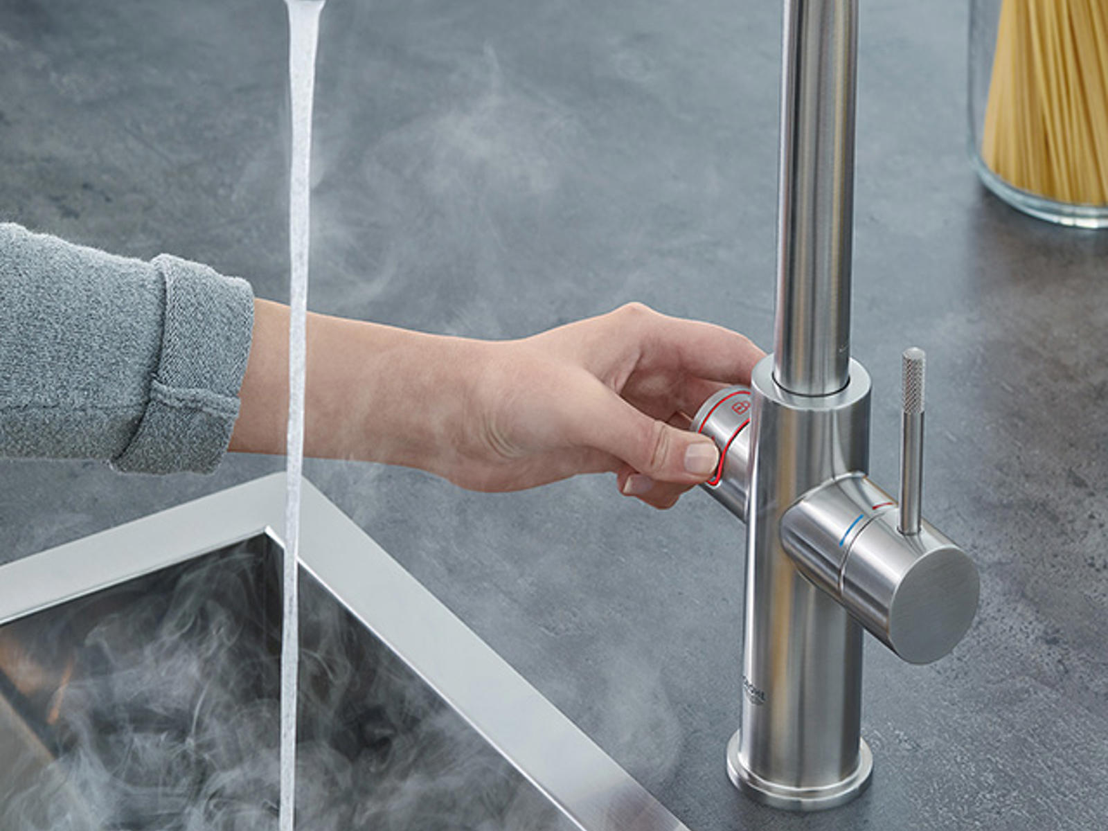 GROHE rvs kokendwaterkraan met dampend water in een pan boven een spoelbak